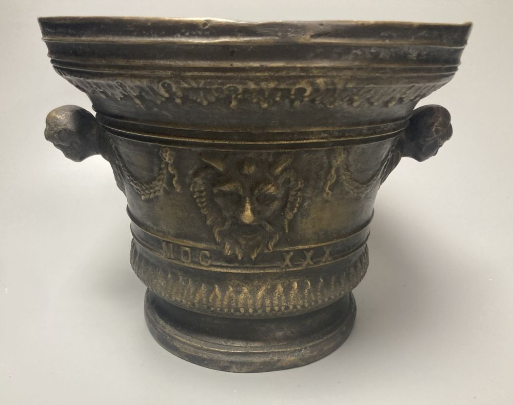 A large bronze mortar and pestle, bearing mock date 1630, 25cm diameter, and two iron and brass canon models